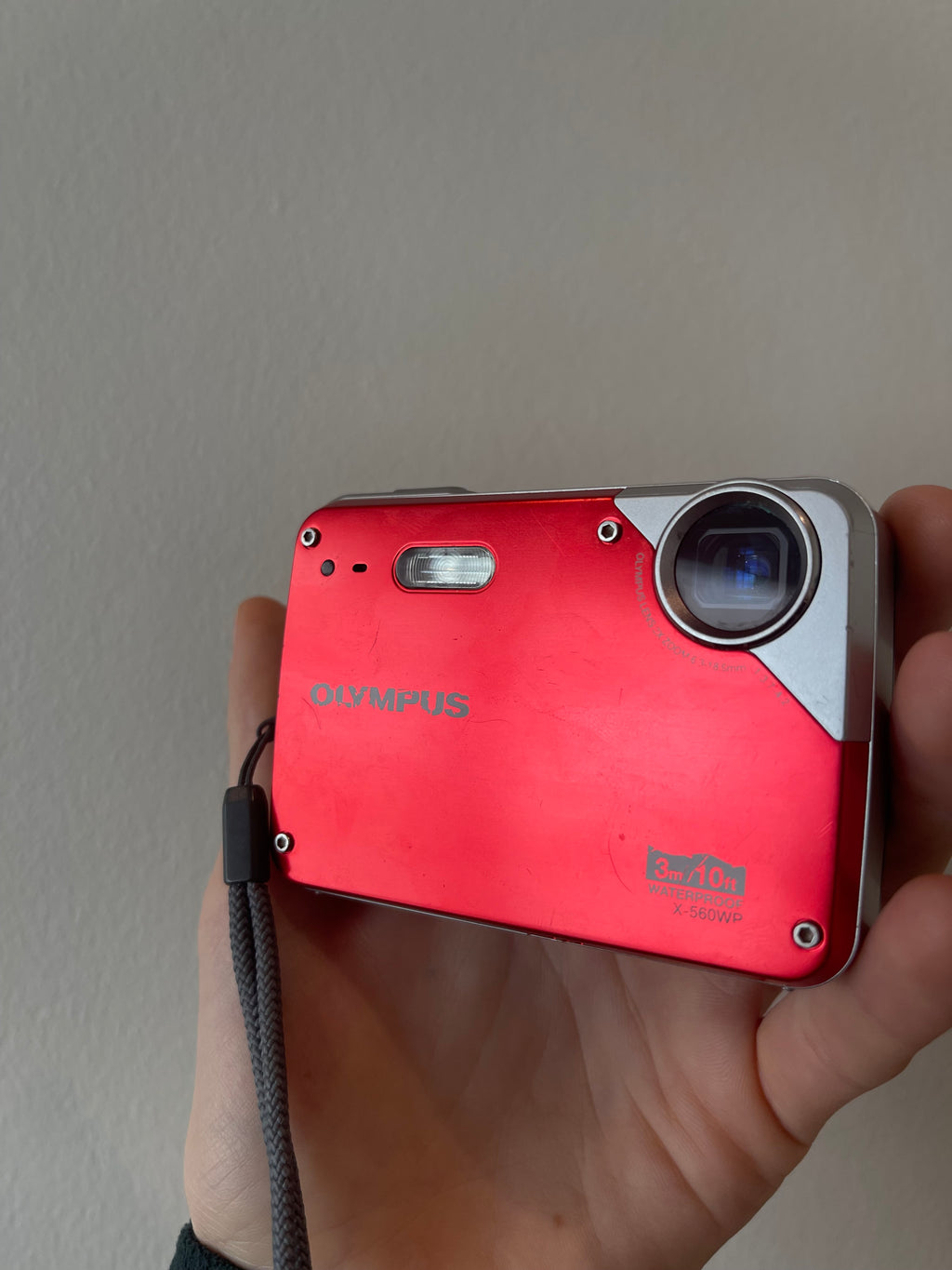Red Olympus X-560 digital camera